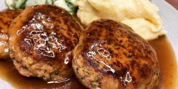 Fleischpflanzerl mit Kartoffelpüree und Gurkensalat.